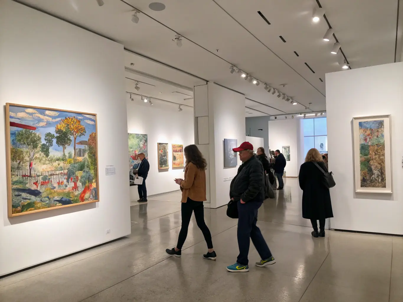 A photograph of an art exhibition at STUDIO DE LA GRANGE, showcasing the works of emerging artists and highlighting the organization's commitment to supporting new talent.